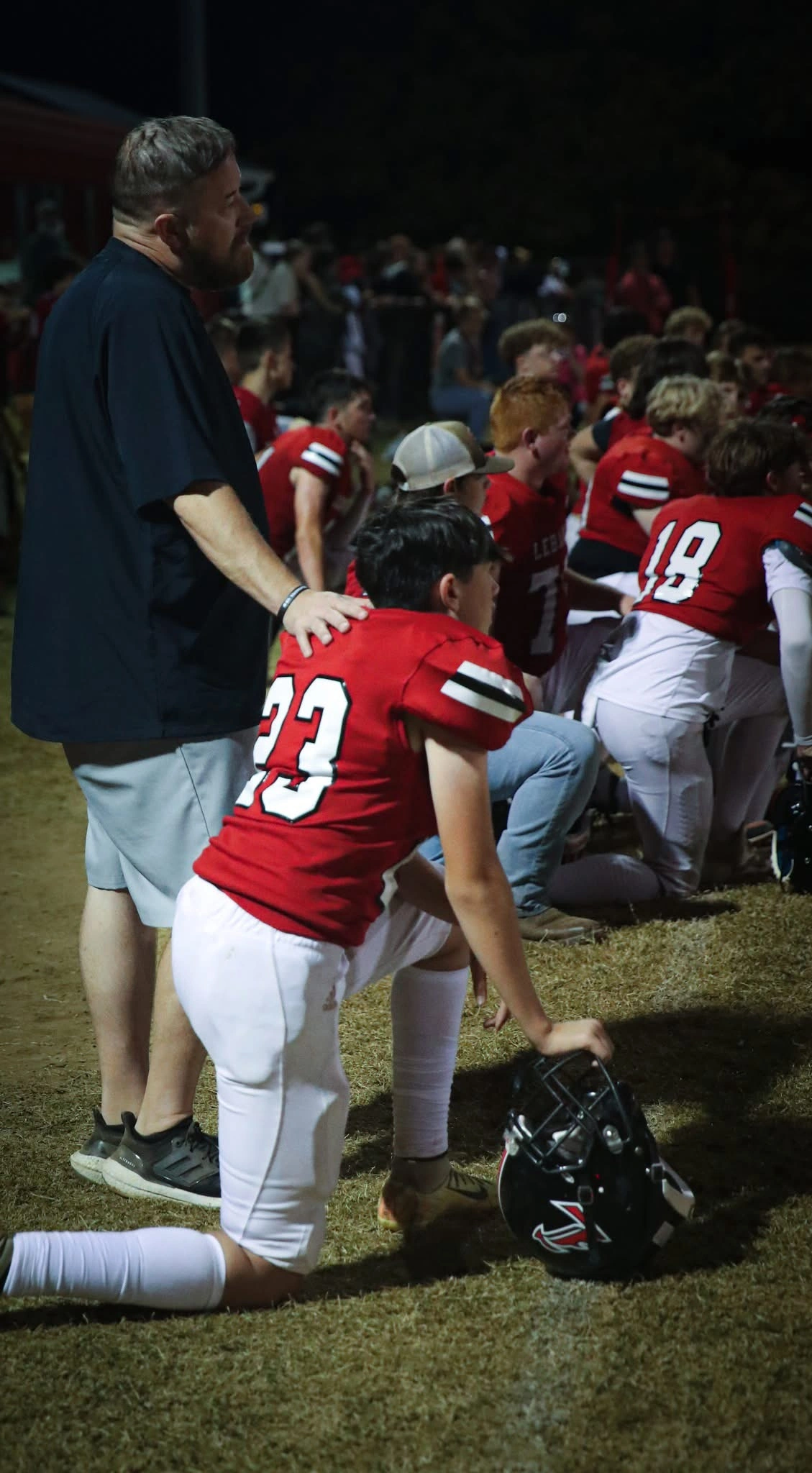 Players kneeling in prayer